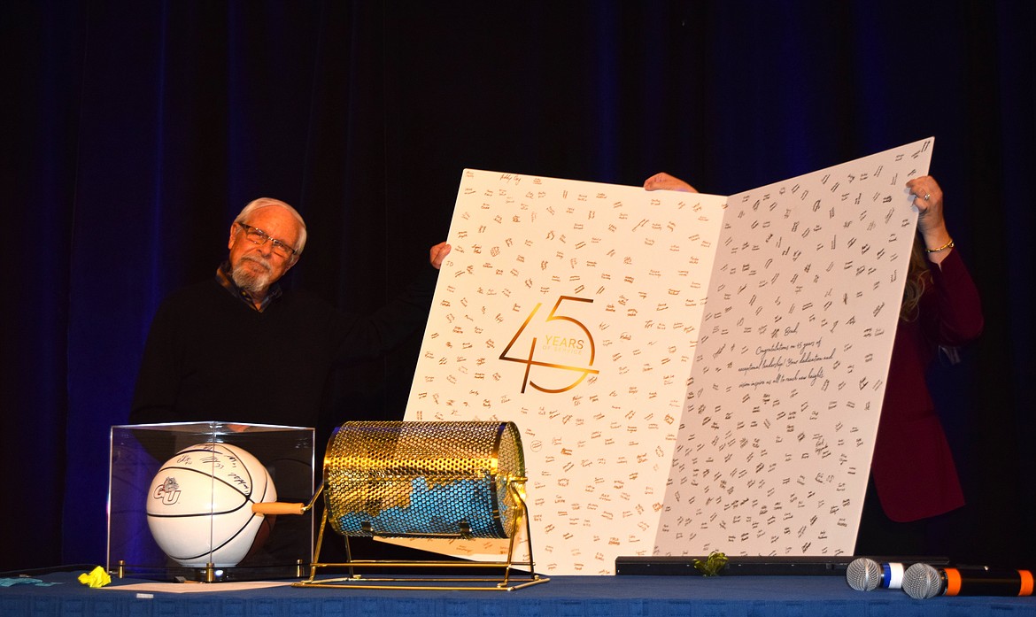 Brad Hagadone received a giant card, which was signed by hundreds of Hagadone Hospitality employees, honoring his 45 years of service during Thursday's After 5 Luncheon at The Coeur d'Alene Resort.