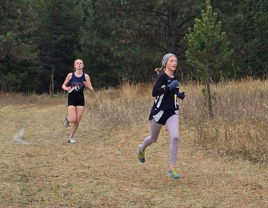 Courtesy photo
Timberlake's Vanessa McLachlan keeps her lead on Coeur d'Alene Charter's Annabelle Carr during the 4A District 1 girls cross country race at Farragut State Park on Thursday.