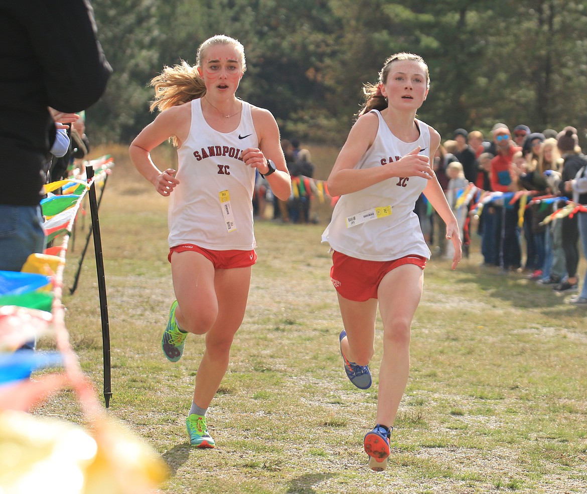 Sandpoint High sophomore Elizabeth Storms (left) and freshman Gracie Maltby (right), who finished fifth and sixth respectively, near the finish line on Thursday.