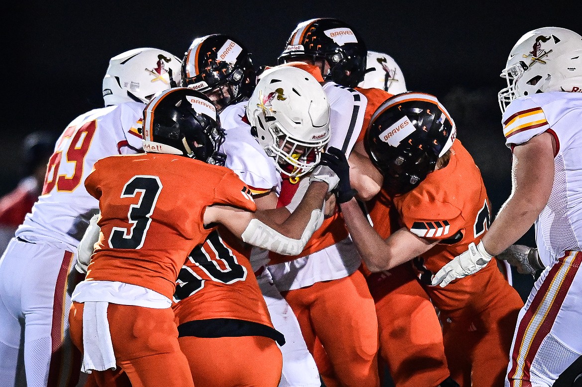 Flathead defenders stop a run by Missoula Hellgate running back Cole Zeigler (8) in the third quarter at Legends Stadium on Friday, Oct. 25. (Casey Kreider/Daily Inter Lake)