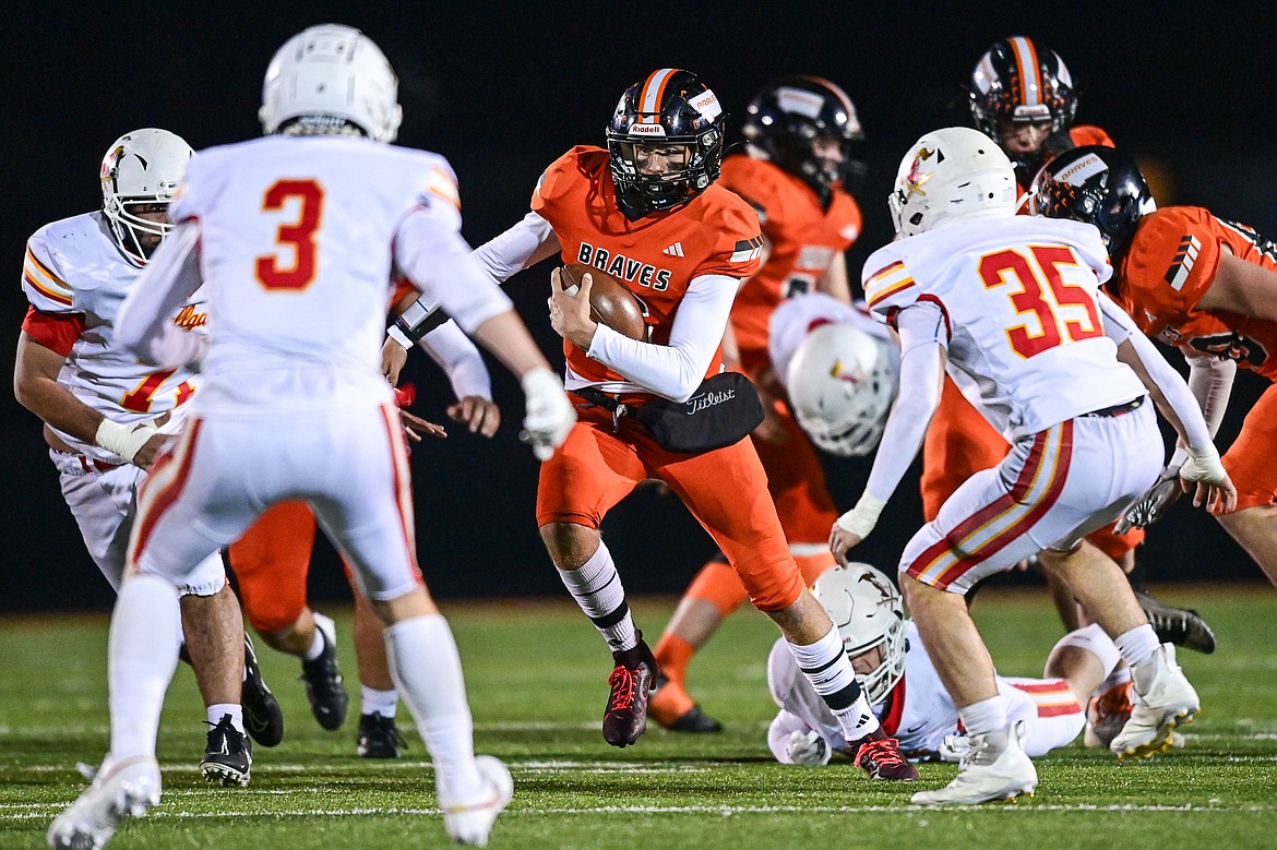 Flathead quarterback Eli Coopman (6) picks up yardage on a run in the third quarter against Missoula Hellgate at Legends Stadium on Friday, Oct. 25. (Casey Kreider/Daily Inter Lake)