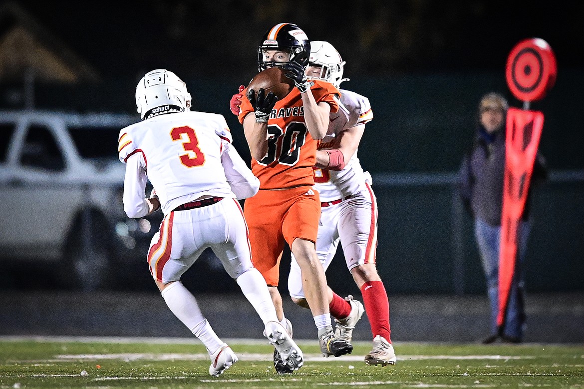 Flathead wide receiver Jack Blodgett (80) hangs on to a reception in the fourth quarter against Missoula Hellgate at Legends Stadium on Friday, Oct. 25. (Casey Kreider/Daily Inter Lake)