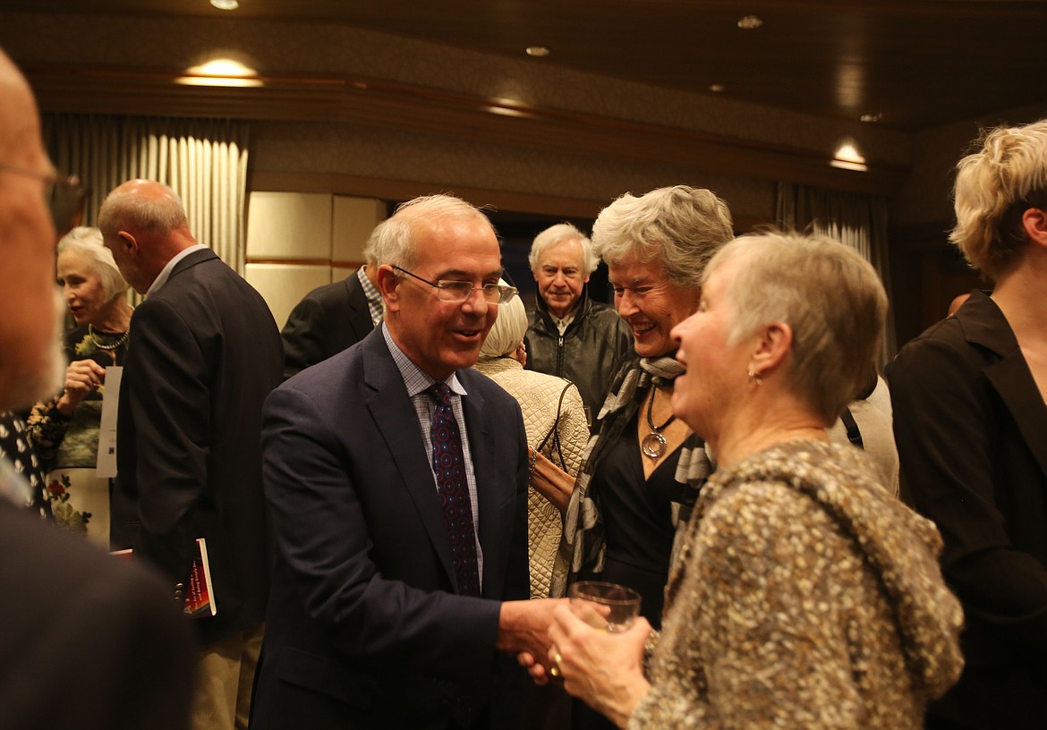 Best-selling author and political commentator David Brooks shakes retired art teacher Jane Morgan's hand Thursday evening at a private reception before the Idaho Humanities Council’s North Idaho Distinguished Lecture and Dinner at The Coeur d'Alene Resort.