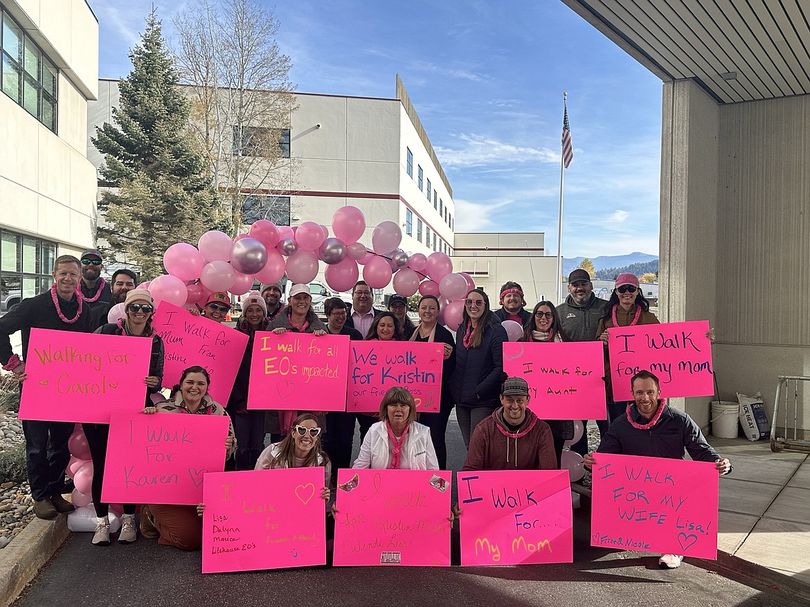 Litehouse employees pose for a group photo Friday along with the posters they created showing who they walked for during the company's first breast cancer awareness walk.