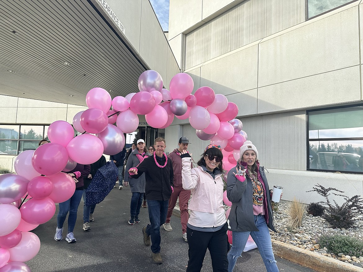 Litehouse employees wave as they head out on the company's breast cancer awareness walk on Friday.