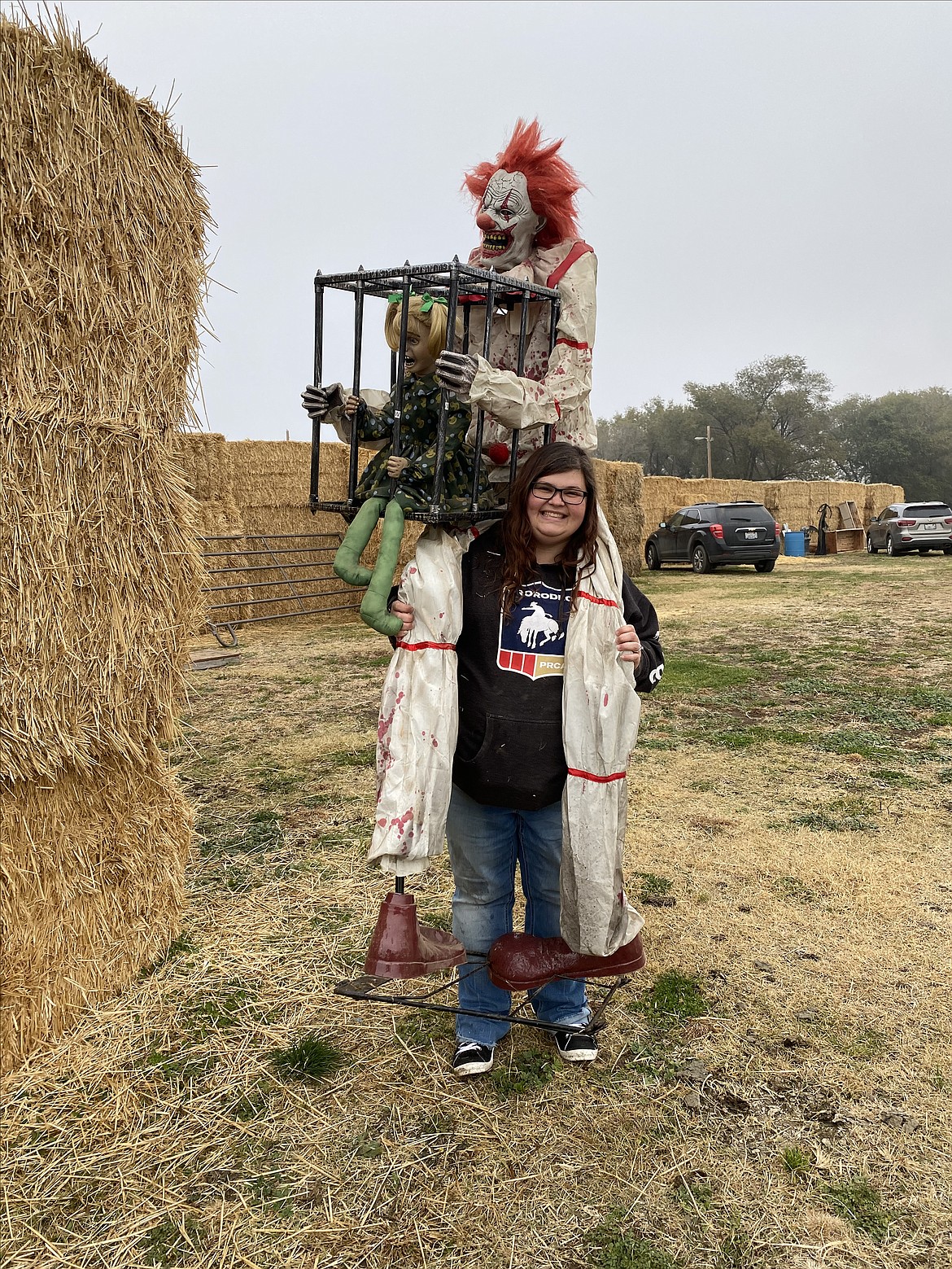 Volunteer Kaela McIndoe carries a – okay, that’s not a nice clown – into the straw maze sponsored by the Othello Rodeo Association.