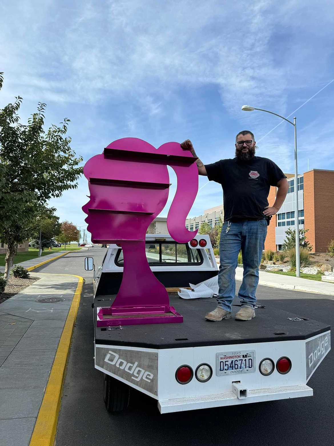 Seth Miner, owner of Miner Services LLC, delivers the pink barbie shelf to the Boys and Girls Club of Grant County for their silent auction.