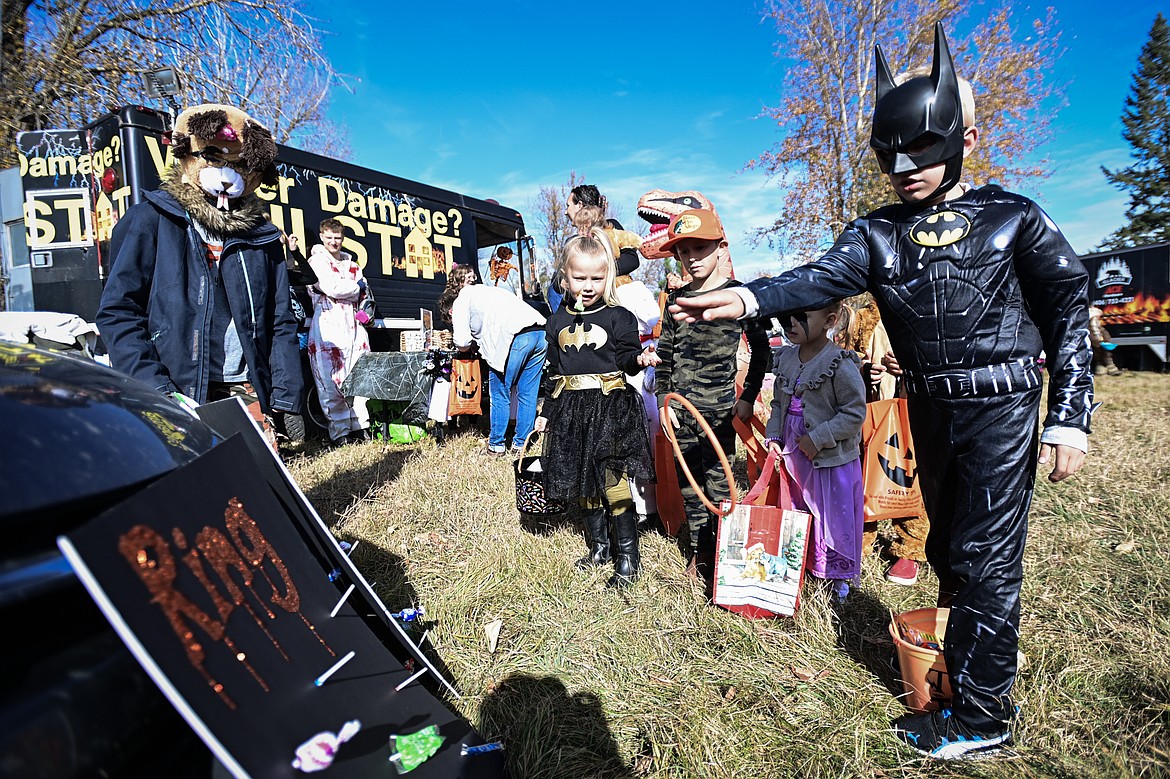 Trunk-or-treaters play a game of ring toss for candy at the Evergreen Trunk-or-Treat at the Kalispell Moose Lodge on Saturday, Oct. 26. (Casey Kreider/Daily Inter Lake)