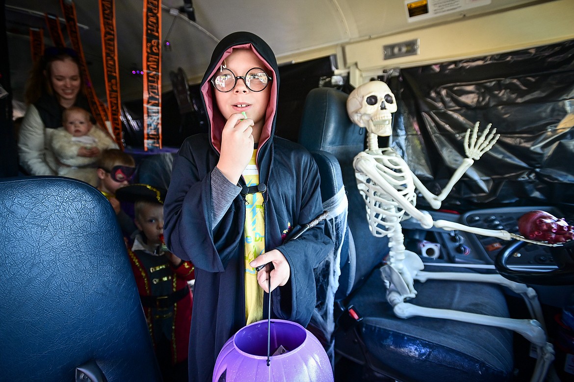 Trunk-or-treaters walk through a haunted schoolbus at the Evergreen Trunk-or-Treat at the Kalispell Moose Lodge on Saturday, Oct. 26. (Casey Kreider/Daily Inter Lake)