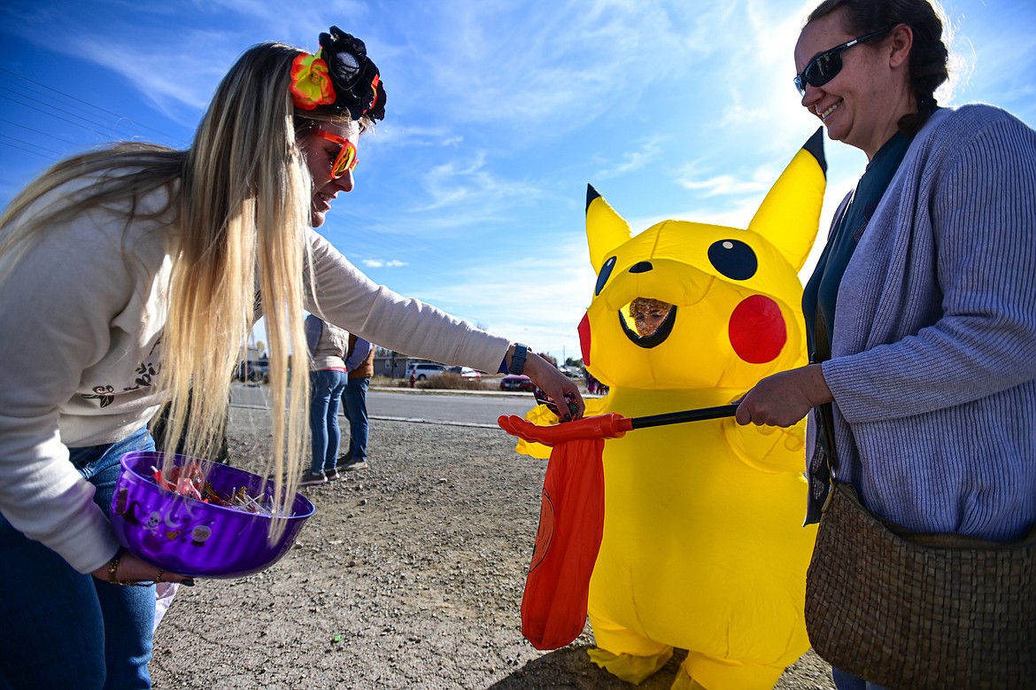 Costumed trunk-or-treaters collect pieces of candy at the Evergreen Trunk-or-Treat at the Kalispell Moose Lodge on Saturday, Oct. 26. (Casey Kreider/Daily Inter Lake)