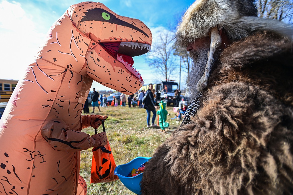 Trunk-or-treaters collect pieces of candy at the Evergreen Trunk-or-Treat at the Kalispell Moose Lodge on Saturday, Oct. 26. (Casey Kreider/Daily Inter Lake)