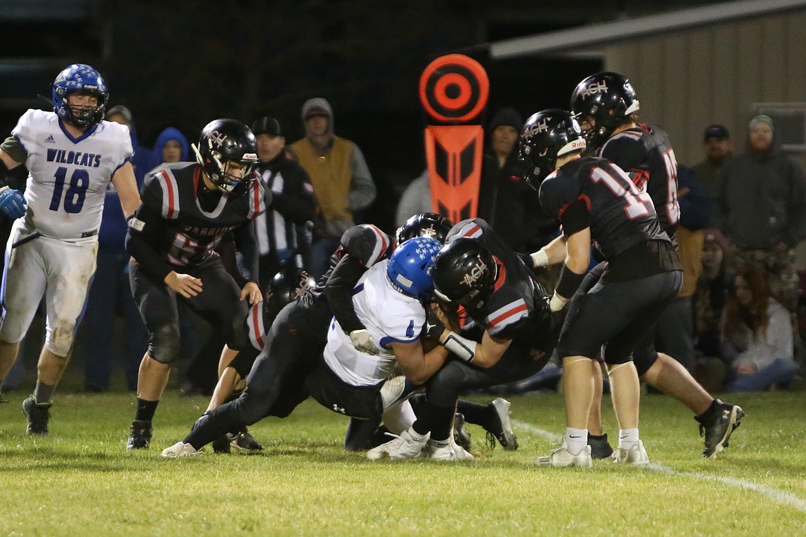 Almira/Coulee-Hartline defenders go in for a tackle against a Wildcat ball carrier Friday night in Coulee City.