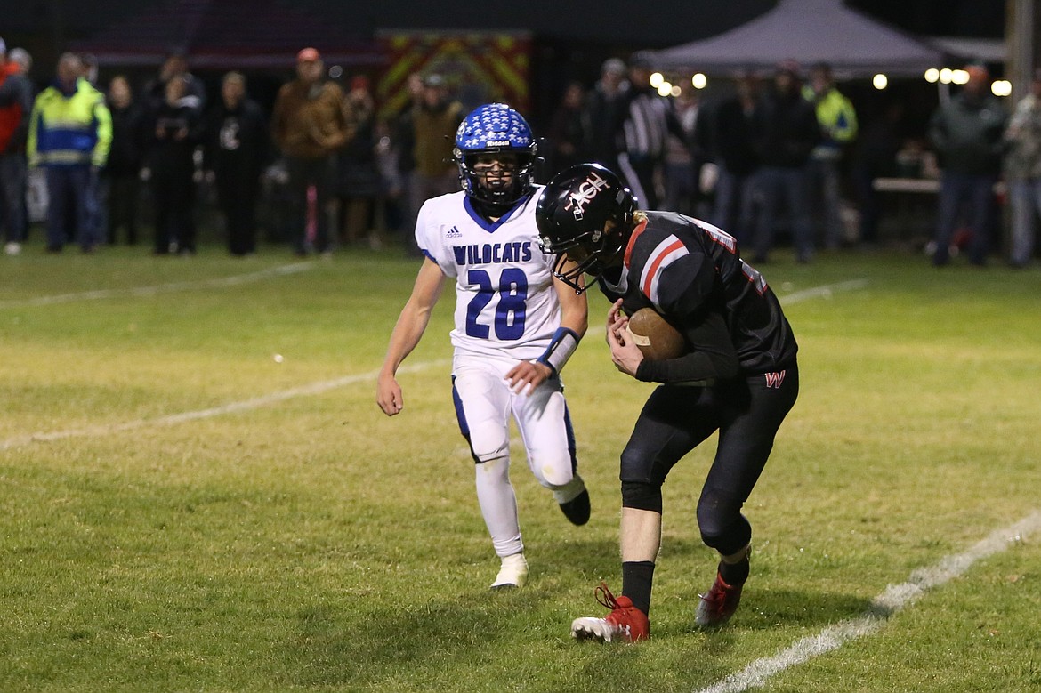 Almira/Coulee-Hartline junior Adyn Peha, in black, catches a 14-yard touchdown late in the first half against Wilbur-Creston-Keller on Friday.