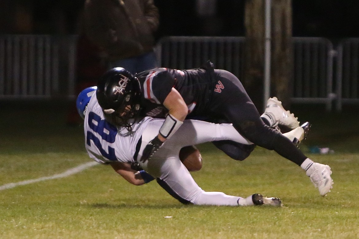 Warrior sophomore Brody Pitts (10) knocks the ball loose on a tackle in the first half against the Wildcats.