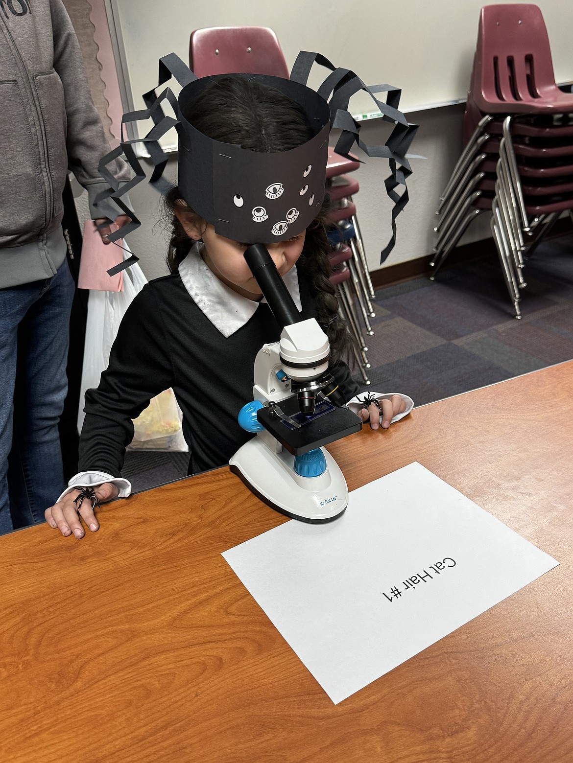 Eden Barajas on the microscope during last week's Spooky STEM Night at Fernan STEM Academy.