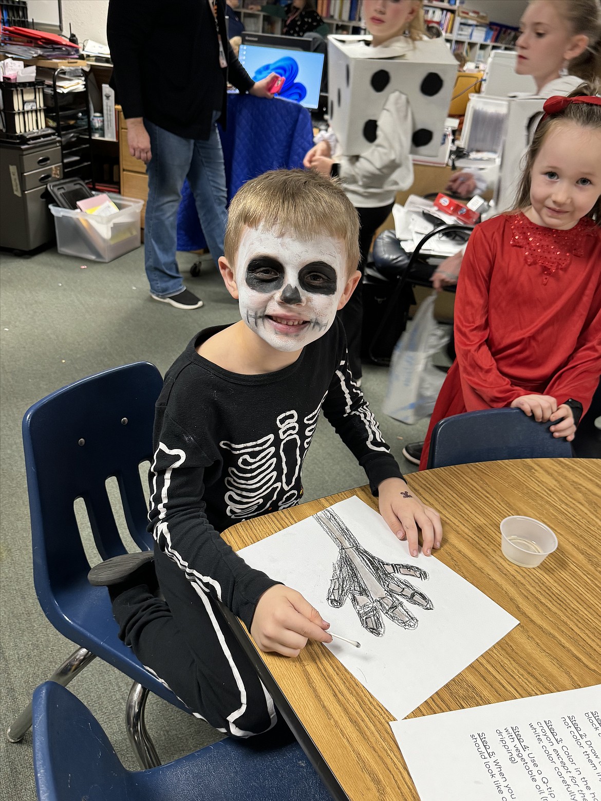 Lukas and Remilee Wright make skeleton hands during last week's Spooky STEM night at Fernan STEM Academy.