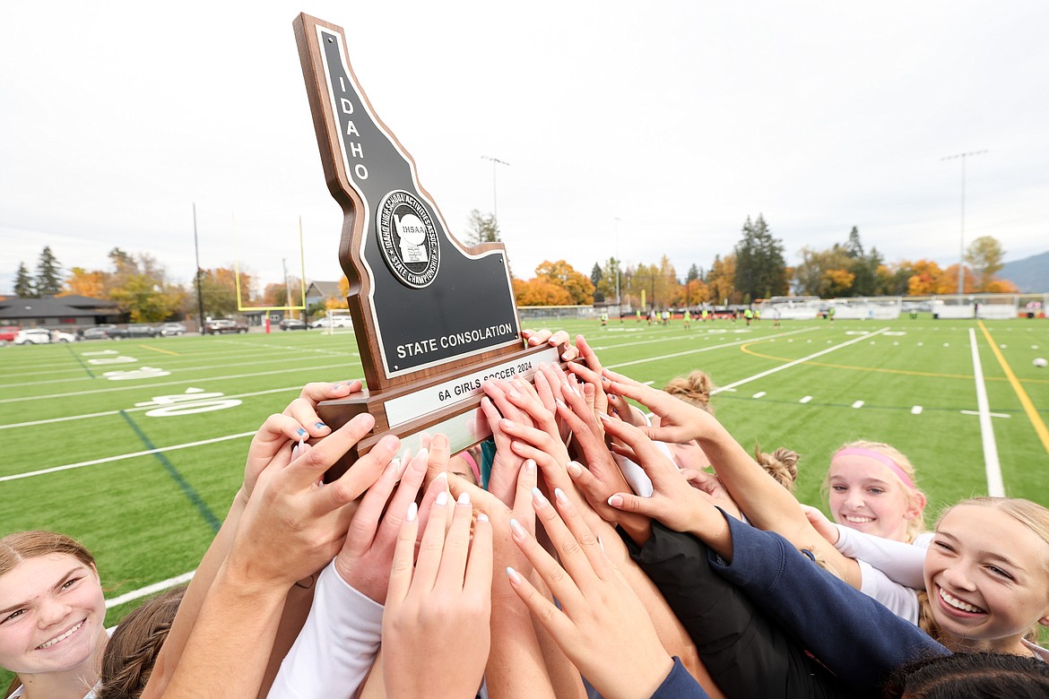 JASON DUCHOW PHOTOGRAPHY
Lake City girls get their hands on the trophy after beating Bishop Kelly to win the state 6A girls soccer consolation championship Saturday morning at War Memorial Field in Sandpoint.