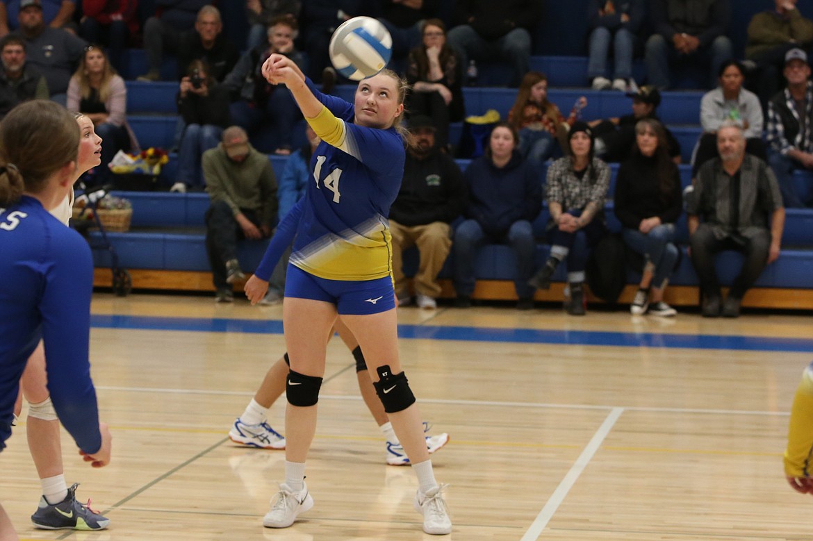 Wilson Creek senior Maddie Finkbeiner (14) bumps the ball back over the net during Thursday’s match.