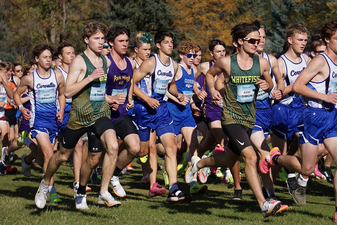 Seniors Ethan Amick (left) and Simon Douglas (right) vie for position early at the MHSA State Cross Country meet in Missoula on Saturday. (Matt Weller photo)