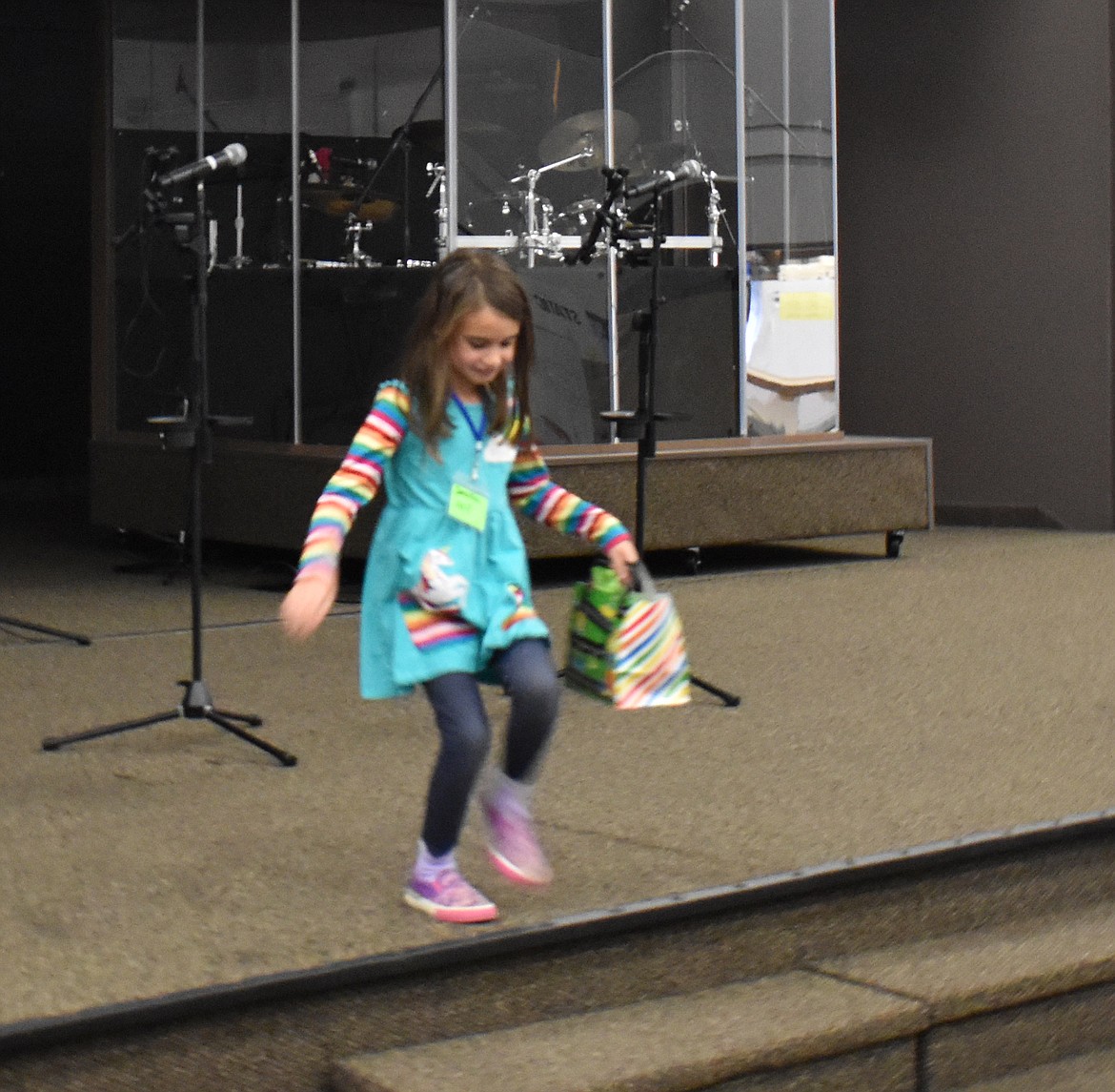 First-grader Samantha Wolf trots off the stage after receiving her third-place award for her exhibit at the Little House in the Desert Homeschool Group Science Fair Saturday. Samantha’s experiment looked at the effect of soft drinks on raisins.