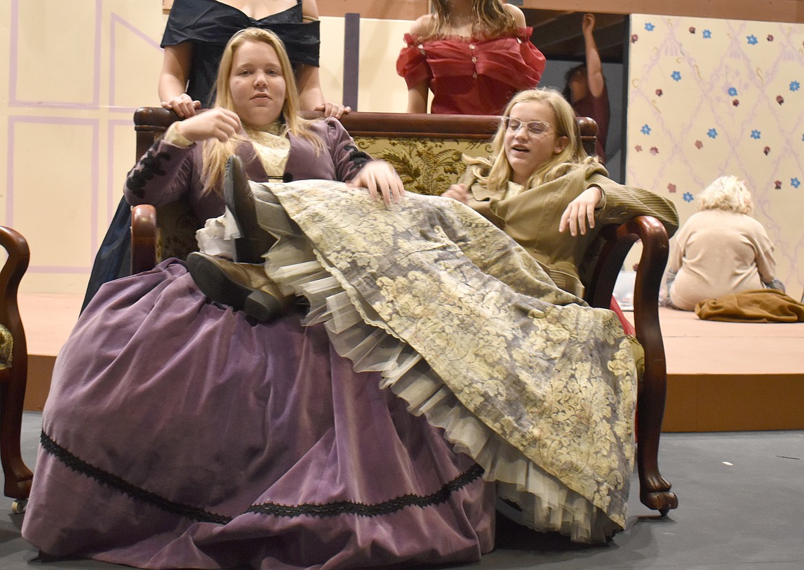 Meg (Michaela Greely), left, is a little nonplussed by her sister Jo’s (Belle Rollins) lack of ladylike posture in the Quincy High School performance of “Little Women.”