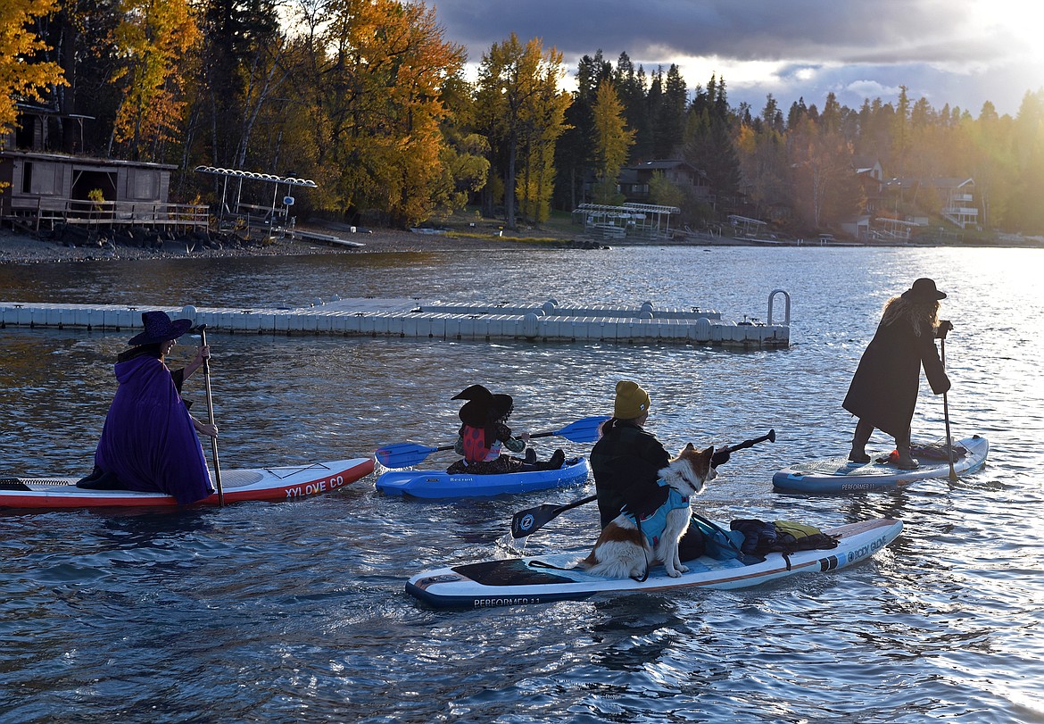 Dozens of residents and their fluffy friends dress as witches  for a fun, spooky venture sweeping and paddling down Whitefish Lake and River on Oct. 17. (Kelsey Evans/Whitefish Pilot)