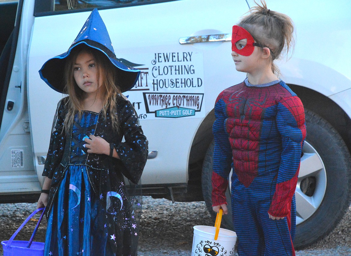 A witch and Spiderman wait on their numbers during the cake walk event at the St. Regis Fall Festival on Saturday afternoon. Over 30 baked goods were donated and awarded to the (Mineral Independent/Amy Quinlivan)