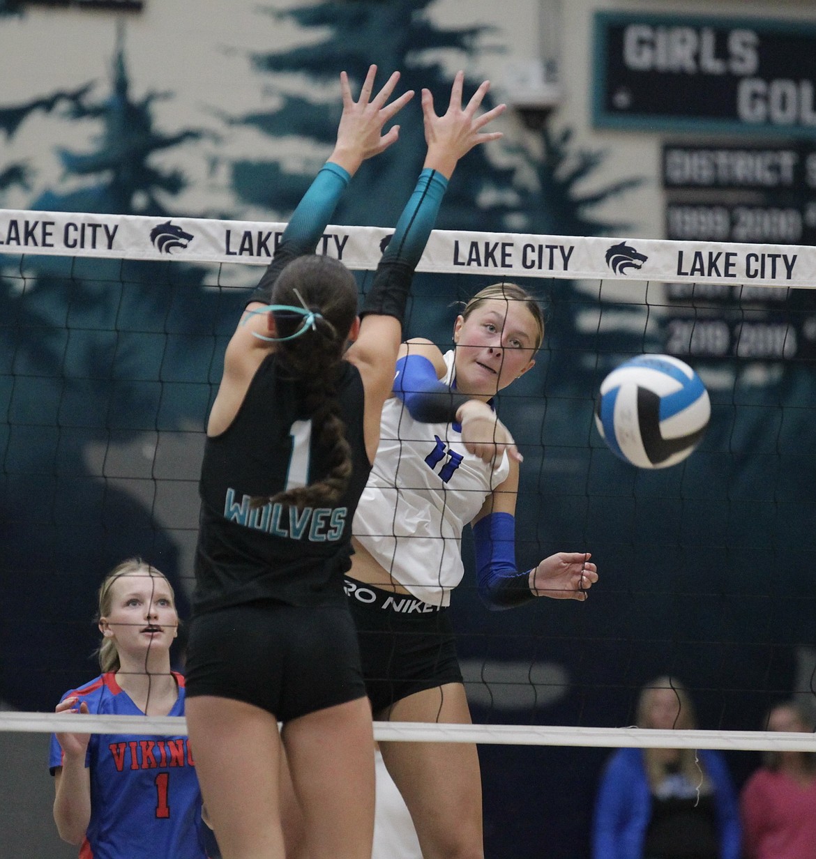 MARK NELKE/Press
Coeur d'Alene junior Gianna Callari (11) hits past Lake City sophomore Camryn Woodman (1) in the 6A District 1 championship match last Tuesday at Lake City.