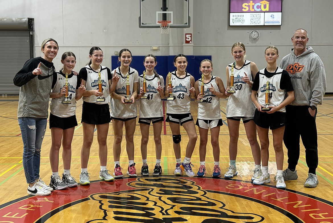 Courtesy photo
The Hooptown Blazers, a seventh grade AAU girls basketball team with players from Coeur d’Alene and the Spokane area, won the Spokane Boo Ball Fall Classic last weekend. The Blazers beat the Lady Raiders 70-32, OP Nation 82-13, UYF Elite 55-18 and Diamond Lane 69-22 to take first place. From left are coach Nikki White, Bailey Madsen, Layne Whiteman (Coeur d'Alene), Quinn Paulson (Coeur d'Alene), Hadley Sheridan, Kinlee White, Reese Libey, Kennedy Coan, Brightyn Gatten (Coeur d'Alene) and coach Rob Sheridan.