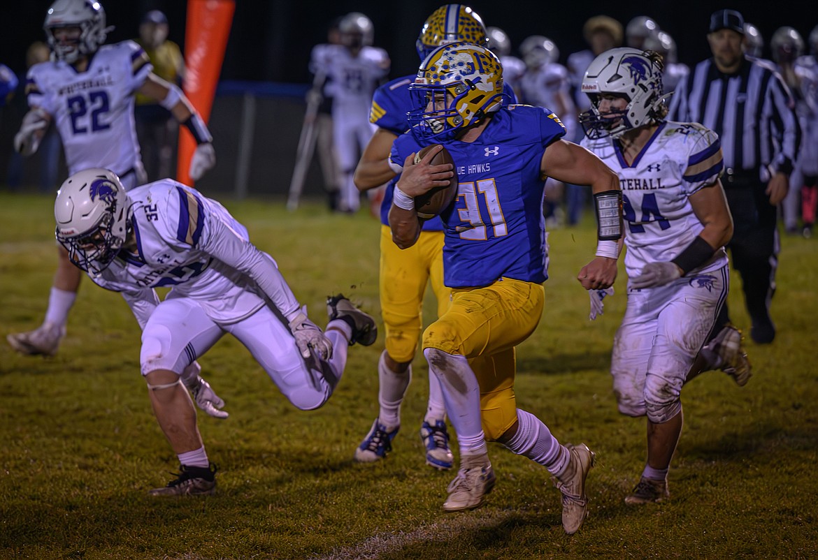 Senior running back Kaiden Robins breaks outside on a long run during Thompson Falls game with Whitehall Friday night in T Falls.  (Photo by Tracy Scott)