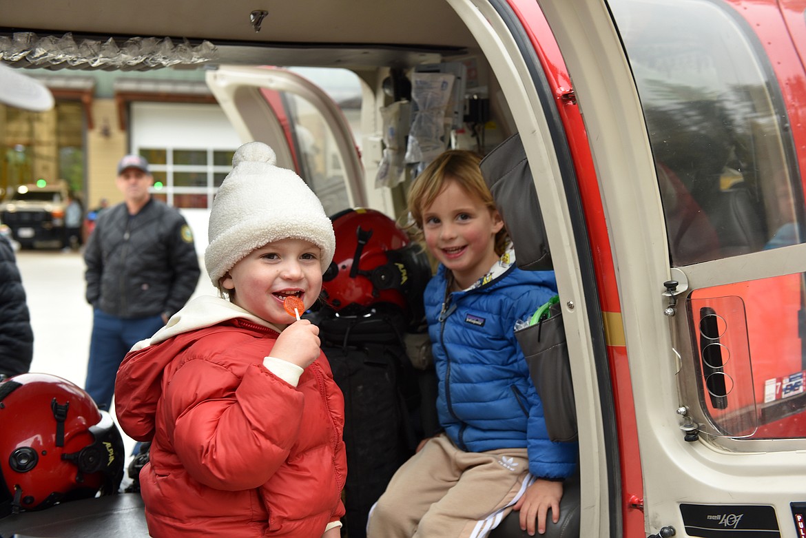 Nova Gardner and Stockley Seemann explore a helicopter at the Whitefish Fire Department open house on Oct. 19. (Kelsey Evans/Whitefish Pilot)