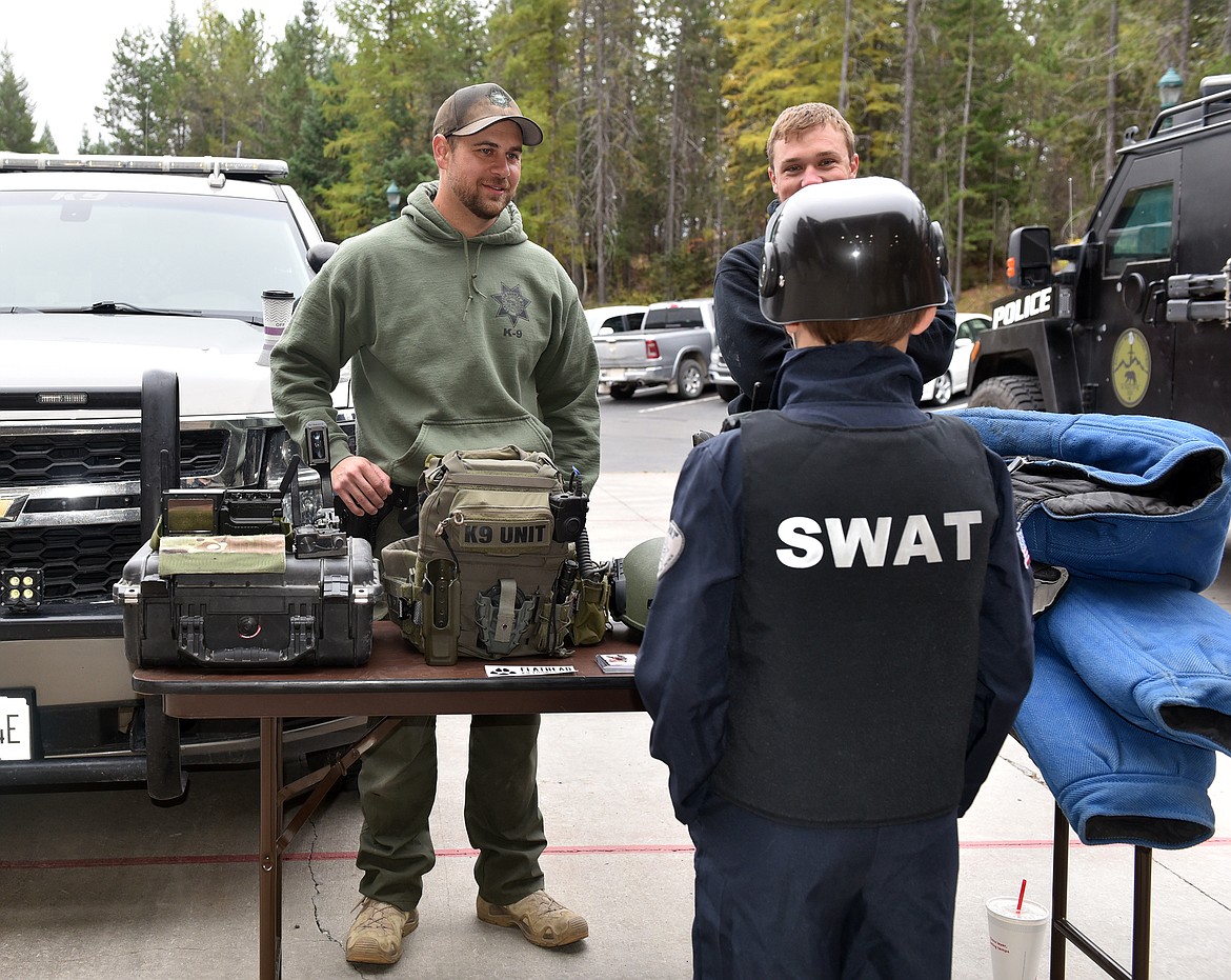 Eight-year-old Zeveric Arseneaux, aspriring SWAT agent, is eager to learn from the search and rescue team at the Whitefish Fire Department's open house on Oct. 12. (Kelsey Evans/Whitefish Pilot)