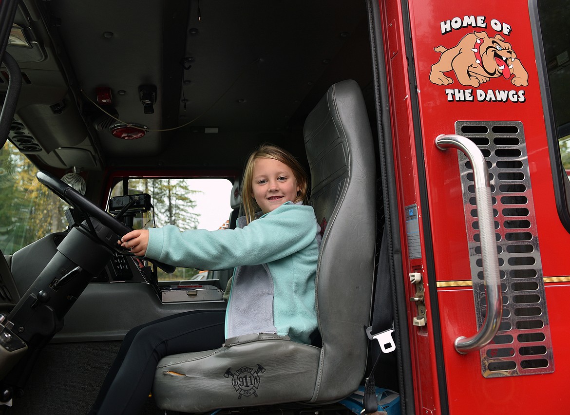 Sloane Good at the wheel of a fire truck at the Whitefish Fire Department's open house on Oct. 19. (Kelsey Evans/Whitefish Pilot)