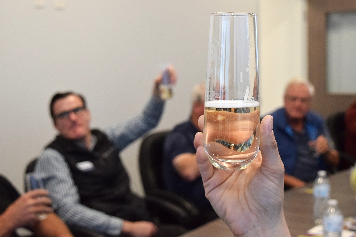 Members of the Okanagan Specialty Fruits roundtable look at the bubbles in the glass during their first cider sample made with Golden Delicious. The ciders are made from Arctic apples which, according to OSF, give their ciders a champagne-like experience.