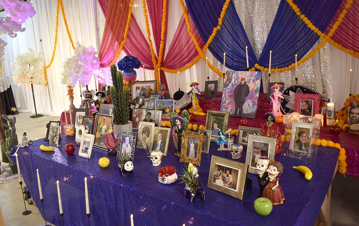 The communal altar at the Moravida Festival held flowers, candles and photos of the deceased.