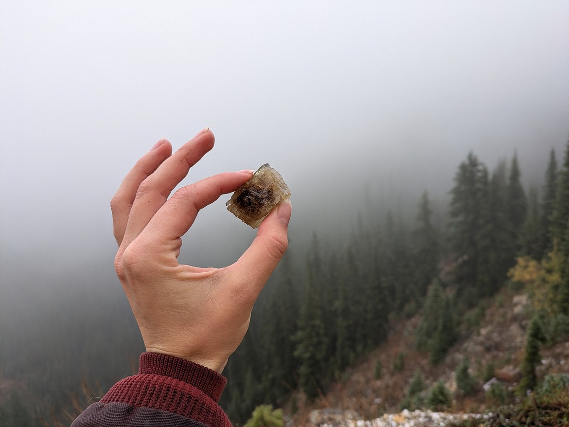 The author holds up a piece of purple fluorite at Snowbird Mine. (Avery Howe/Bigfork Eagle)