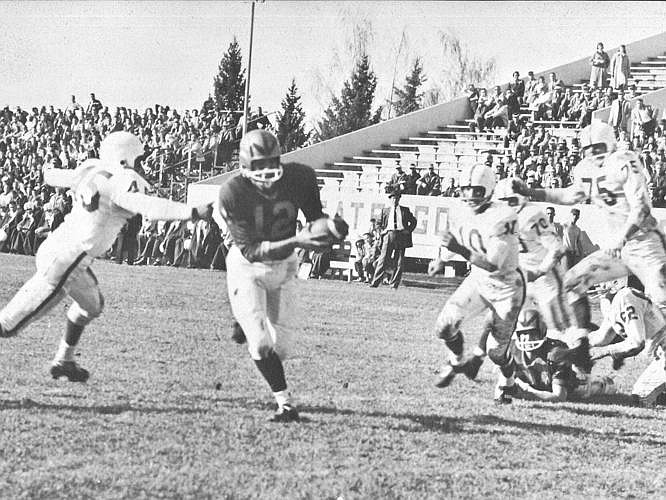 Quarterback Darryl Dupuis carries the ball during a 1959 Bobcat game. (Photo courtesy of the Montanan)