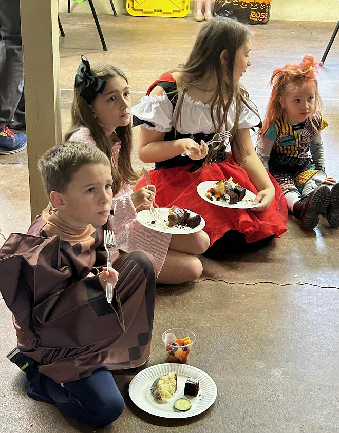 Spark! Co-op North Idaho students enjoy the traditional "bread of the dead," or pan de muerto, Tuesday as they learn about the Mexican holiday Day of the Dead at the Human Rights Education Institute. From left: Owen and Avril Silva, Everly Nelson and Luna Sons.