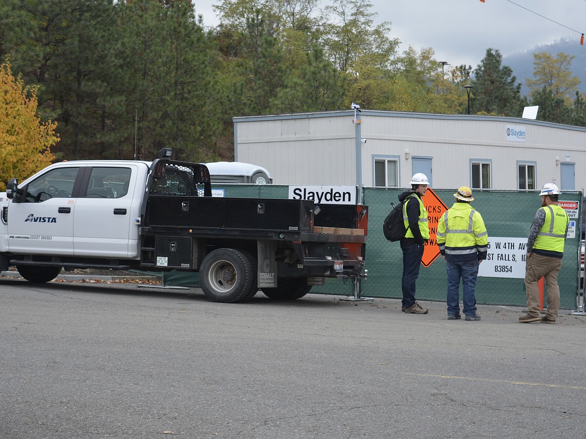 Avista Utilities workers discuss the project at Falls Park, which was temporarily closed after a crane failure Tuesday morning.