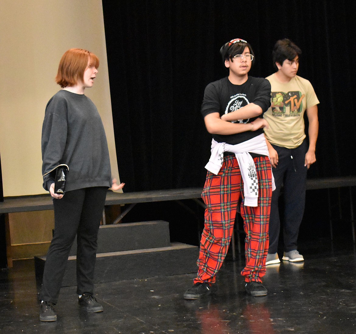 Miss Scarlet (Emma Leavitt) accuses Professor Plum (Enrique Perez) of murder most foul in a rehearsal of the Othello High School production of “Clue.”