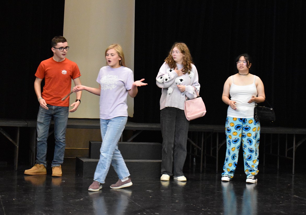 Yvette (Alyse Freeman) assures (from left) Wadsworth (Sawyer Roylance), Mrs. Peacock (Karli Long) and Mrs. White (Sophia Terayama) that she’s all done shooting things during a rehearsal of the Othello High School production of “Clue.”