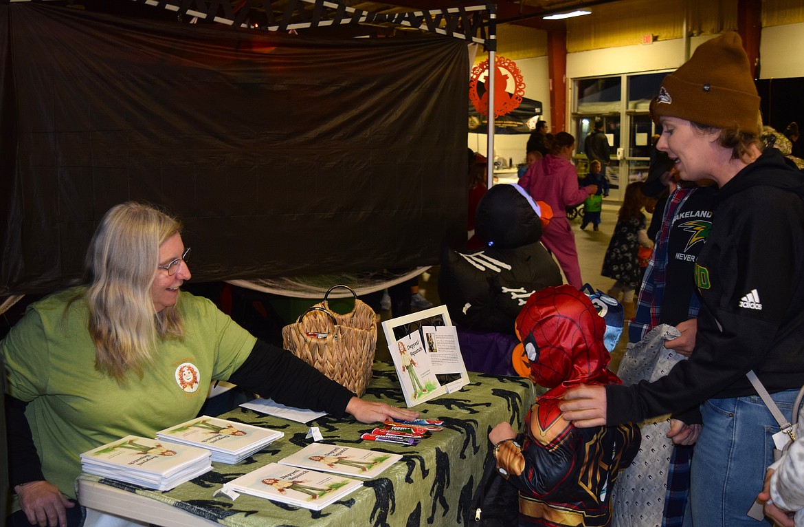 Local children's book author Angela Goodman signs copies of her book "Depyeti Squatch" and talks to local families at the Kootenai County Fairgrounds on Oct. 19.