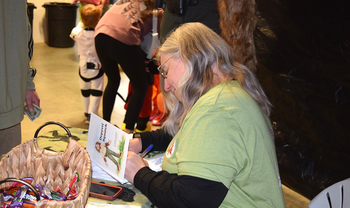 Local children's book author Angela Goodman signs copies of her book, "Depyeti Squatch," at the Kootenai County Fairgrounds on Oct. 19.