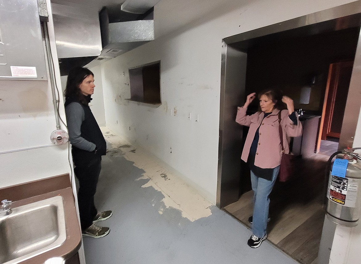 North Idaho College communications coordinator Gerry McCray listens Monday in the empty Fort Ground Grill kitchen as former manager Diane Beck discusses the spooky sounds staff would hear coming from the empty room above the restaurant.