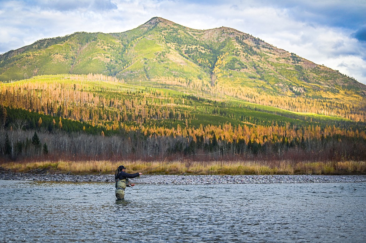 Milan Mena casts a line into the Middle Fork Flathead River below Loneman Mountain. (Casey Kreider/Daily Inter Lake)