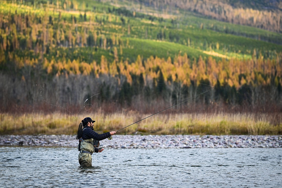 Milan Mena casts a line into the Middle Fork Flathead River below Loneman Mountain. (Casey Kreider/Daily Inter Lake)