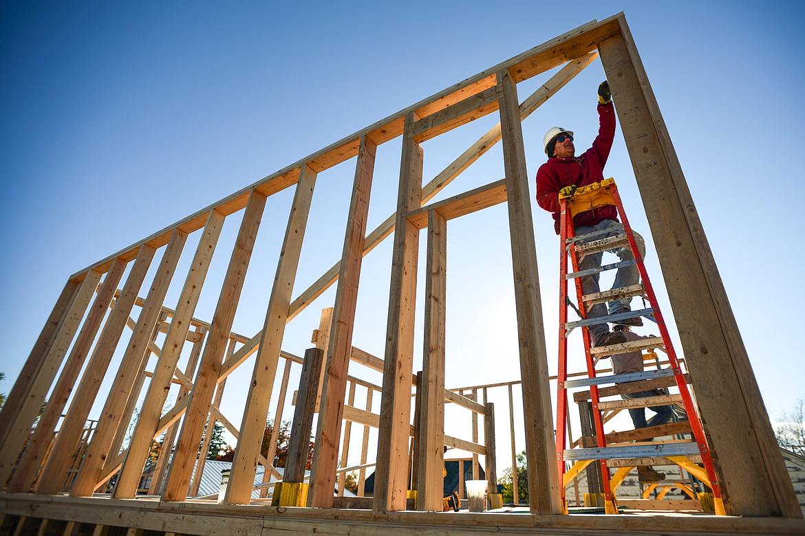 Volunteer Jim Poplin works on the second-floor wall frame of a duplex-style townhouse being built by Habitat for Humanity of Flathead Valley and Northwest Community Land Trust in Kalispell on Wednesday, Oct. 30. (Casey Kreider/Daily Inter Lake)