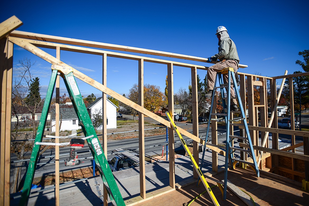 Volunteer Bruce Freeman works on the second-floor wall frame of a duplex-style townhouse being built by Habitat for Humanity of Flathead Valley and Northwest Community Land Trust in Kalispell on Wednesday, Oct. 30. (Casey Kreider/Daily Inter Lake)