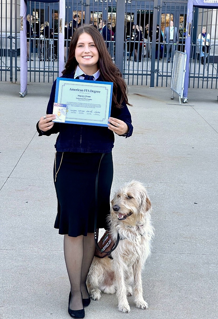 Hayven Chase and her service dog, Scentinel, after Chase received her American degree at the Future Farmers of America Convention in Indianapolis last weekend.