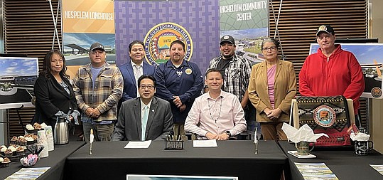 Officials pose for a photo after the Colville signed a memorandum of understanding with the Washington Department of Commerce. Seated: Commerce Director Fong and Confederated Tribes of the Colville Reservation Chairman Jarred-Michael Erickson. Back row, from left: Sharlene Zacherle, Nespelem District, Colville Business Council; Dustin Best, Omak District, Colville Business Council; Al Andy, Commerce Office of Tribal Relations; Roger Finley, Inchelium District, Colville Business Council; Steve Carson, Inchelium District, Colville Business Council; Norma Sanchez, Omak District, Colville Business Council; Kyle Etchison, Keller District, Colville Business Council.